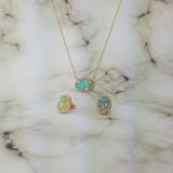 yellow gold pendant with oval cabochon opal and matching earrings