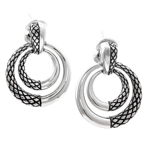 Pair of silver hoop earrings with intricate designs on a white background