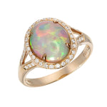 Gold ring with a oval opal stone and diamond halo
 on a white background