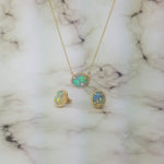 yellow gold pendant with oval cabochon opal and matching earrings